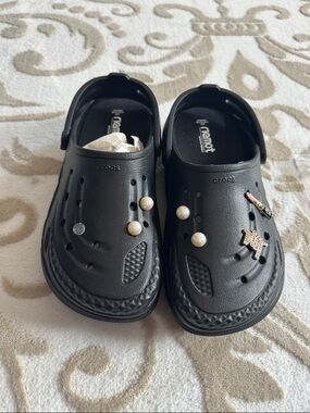 Women’s black Crocs with extra inserts and homemade charms